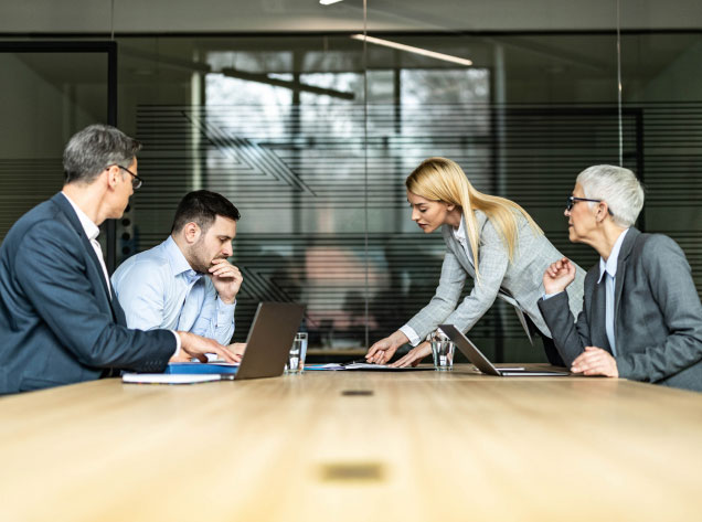 four people in a meeting in a conference room