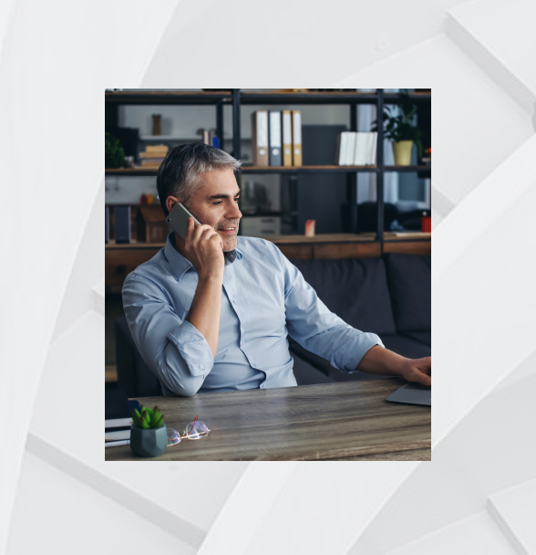 man at desk on the phone