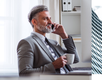 man on cell phone holding coffee cup